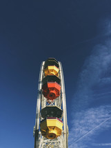 seats on a ferris wheel and blue sky