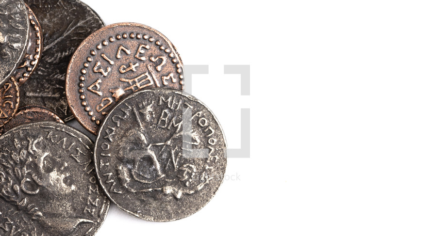 A Pile of Ancient Roman Coin Replicas Isolated on a White Background