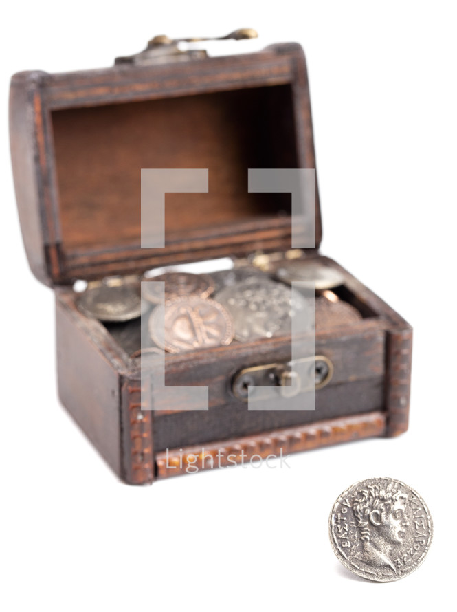 A Treasure Chest Filled with Ancient Coins on a White Background