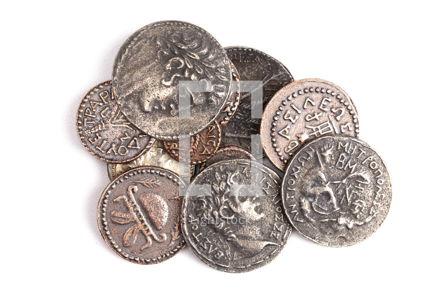 A Pile of Ancient Roman Coin Replicas Isolated on a White Background
