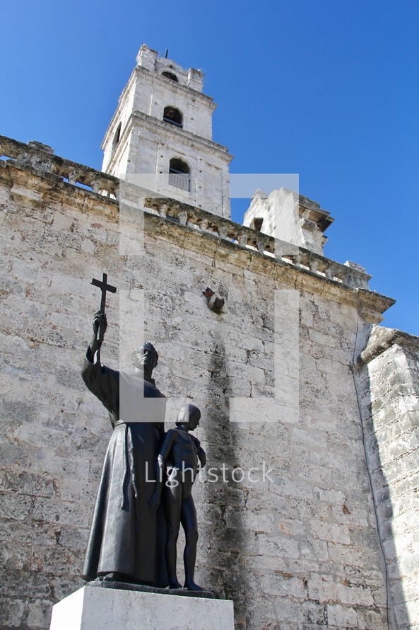 monk statue and church steeple 
