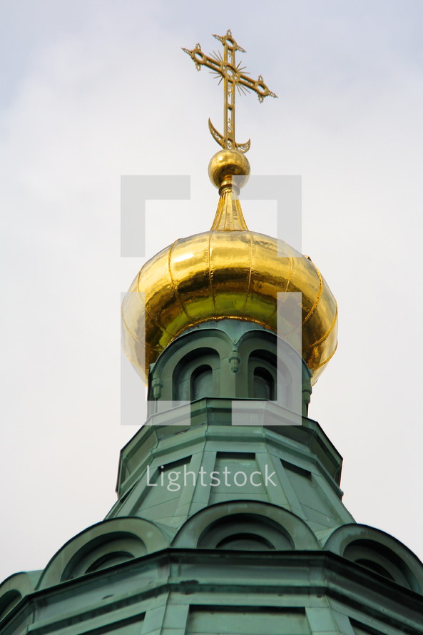 gold cross on a steeple 