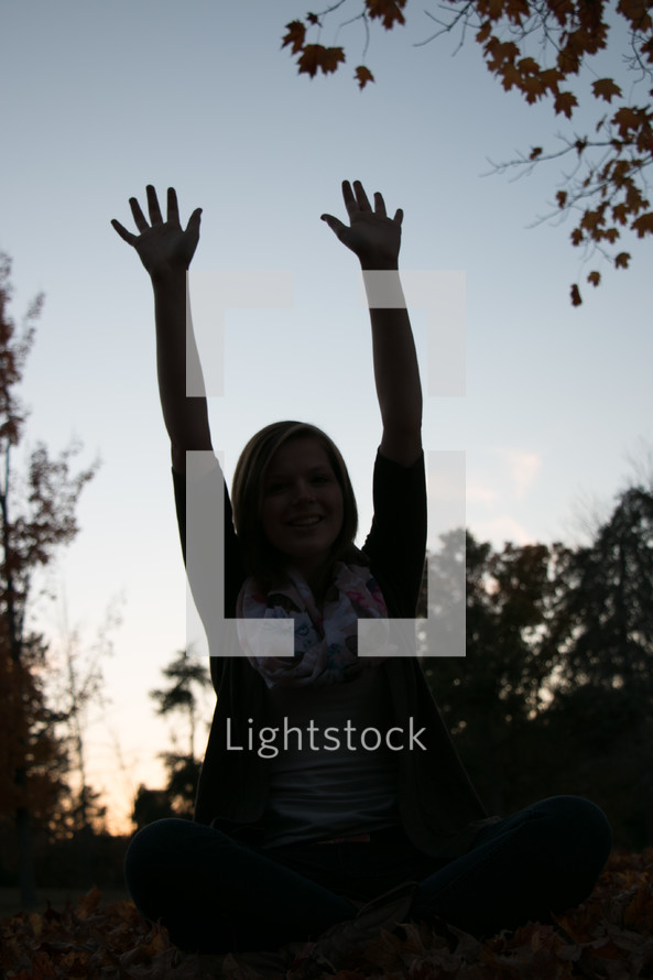 silhouette of a woman with raised arms 