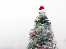 Saran wrap around a Christmas tree 