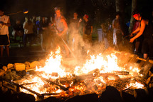 teen gathered around a bonfire 