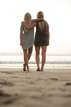 best friends standing together on a beach 