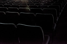 Rows of auditorium chairs.