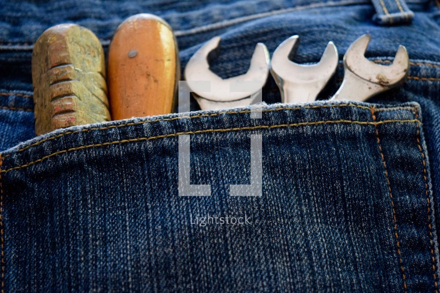 tools in a jeans pocket 