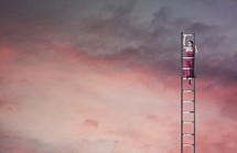woman climbing a ladder into the sky