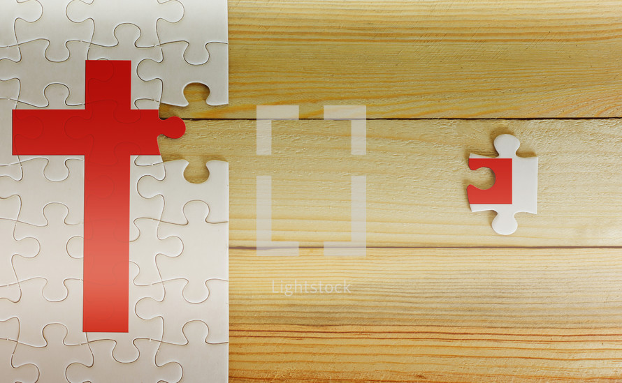 last puzzle piece on a cross puzzle 