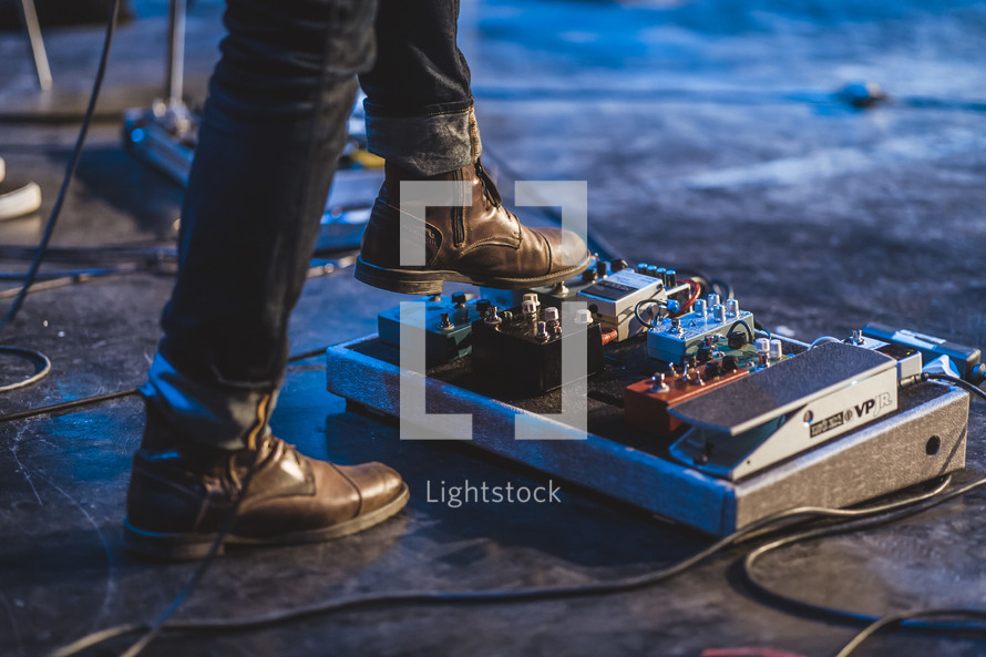 feet on guitar foot pedals 