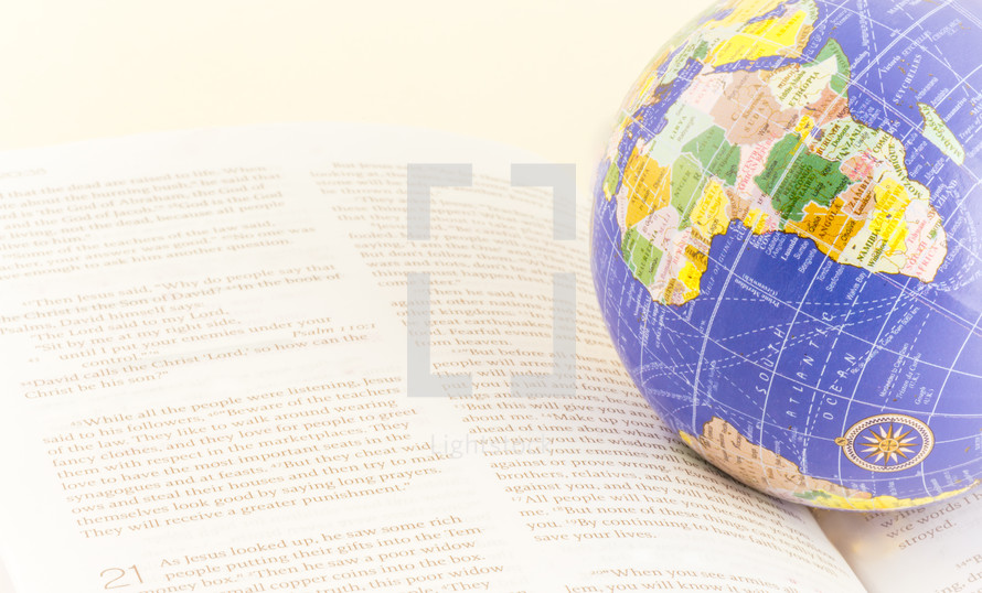 globe on the pages of a Bible 