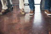 men's feet on a stained concrete floor 