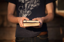 man holding a Bible and journal 