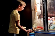 a boy playing in an arcade 