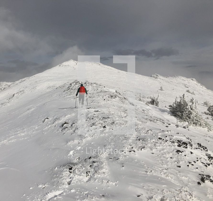 man hiking on a snowy mountain 