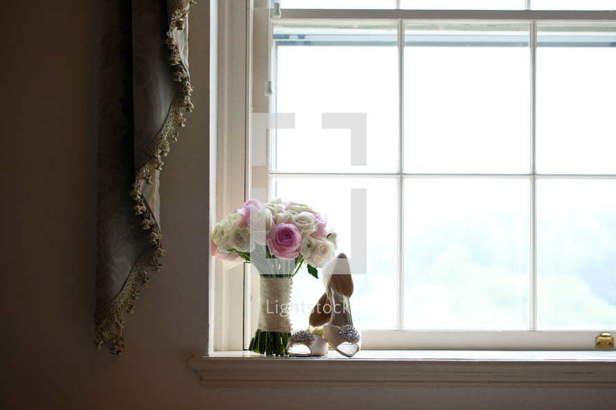 bouquet and heels in a window sill 