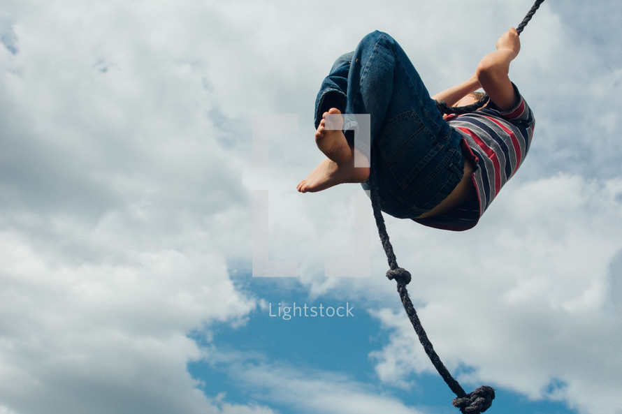 a child swinging on a rope 