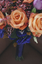 wedding rings and diamond engagement ring in a vase of flowers 