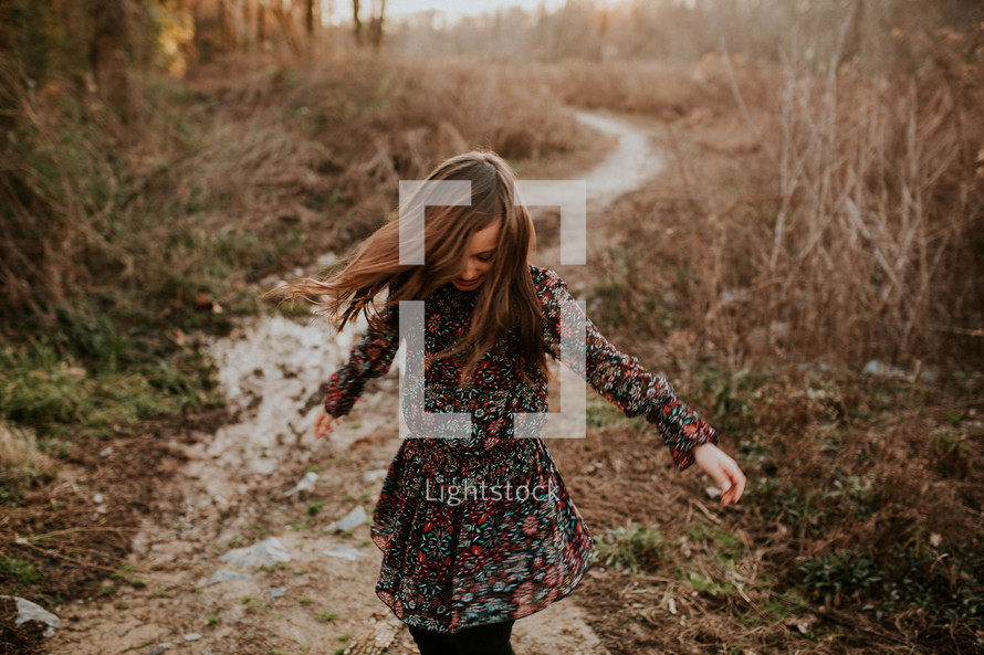 girl in a dress running on a path 