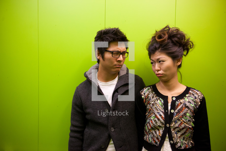 Asian couple frowning 