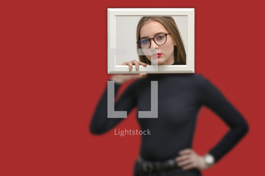 Girl Looking Through Picture Frame on Red Background