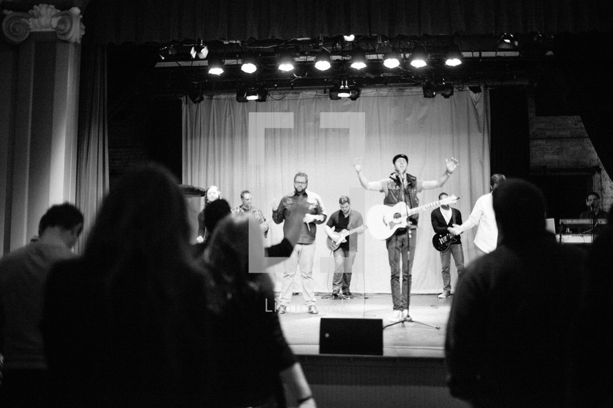 performers on stage singing and praising god