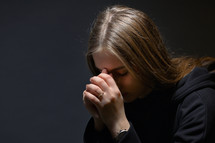 Young Woman Hands Praying in Dark