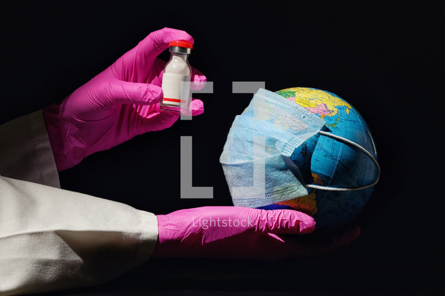Female Hand Hold Earth With Mask And Vaccine Against Virus