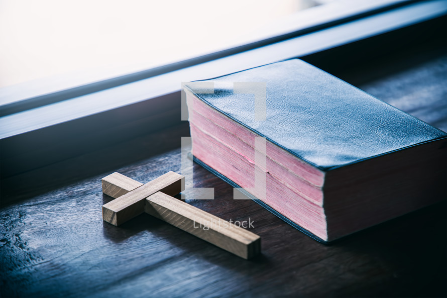 cross and Bible in a window 