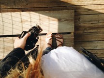 feet of a woman holding a camera 