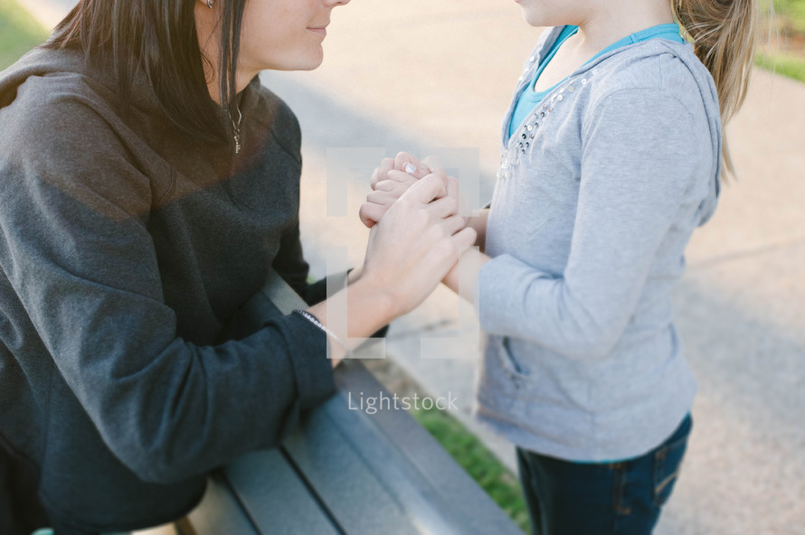mother and daughter holding hands 