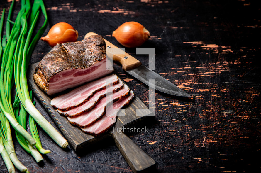 Pork lard cut on a cutting board. Against a dark background. High quality photo