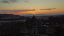 aerial view over a church at sunset 