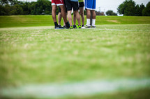 athletes standing on a sports field 