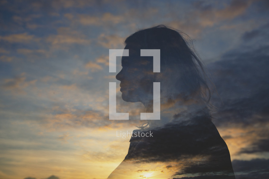 silhouette of a woman and sky at sunrise 