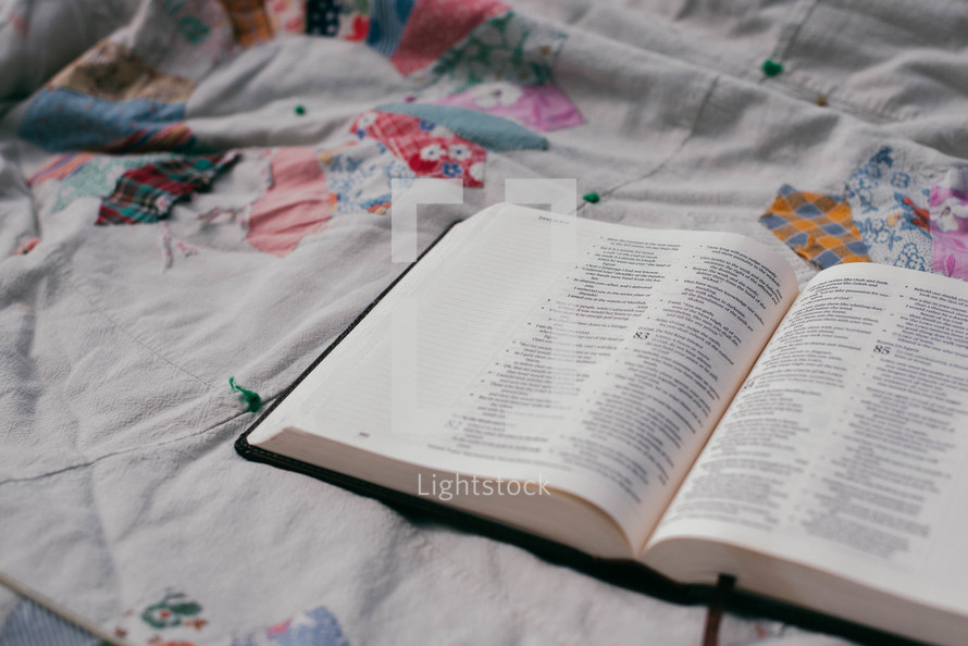 opened Bible on a bed 