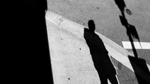 shadow of a man on a sidewalk 
