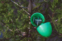 plastic Easter egg filled with a cross