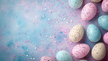 Easter background with pastel colored eggs and confetti on a blue background.