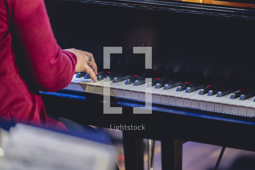 Close up of a woman playing the piano for a church worship service.