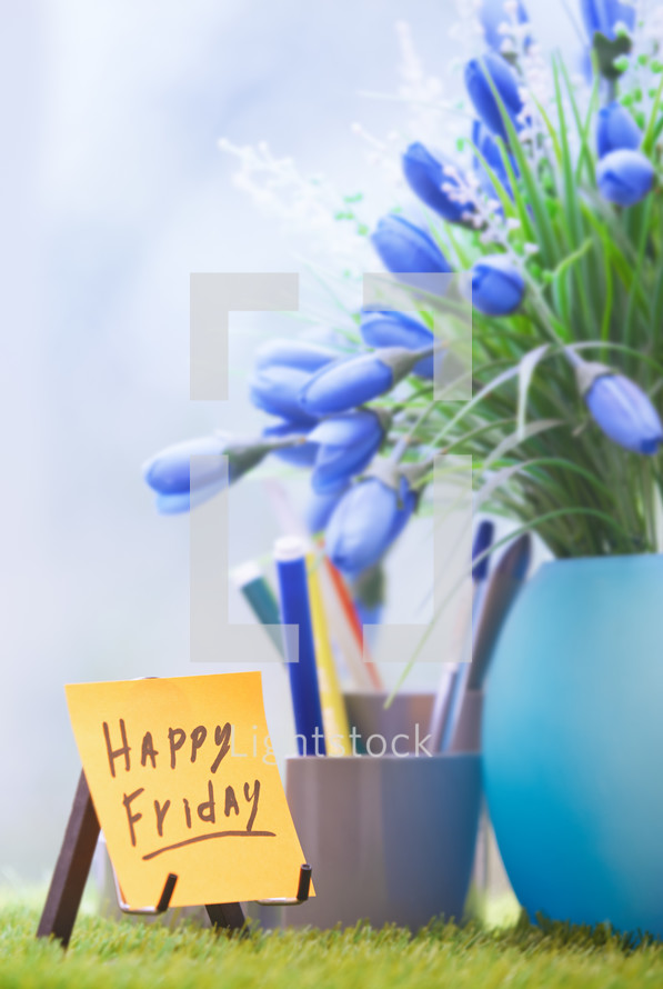 happy friday and blue flowers in a vase 
