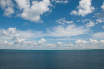 blue sky and white clouds over the ocean