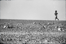 a man running across a desert 