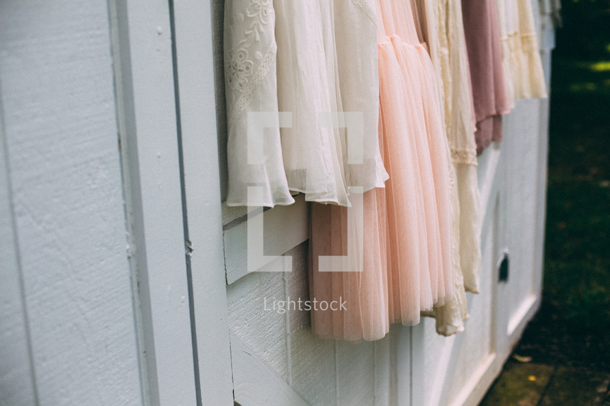 bridesmaid dresses hanging on a barn 