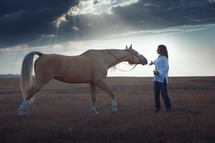 a woman training a horse 