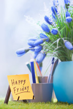 happy friday and blue flowers in a vase 