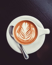 leaf design in creamer in a latte 