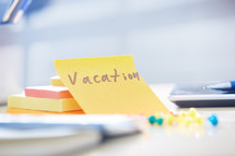 vacation note on a desk 