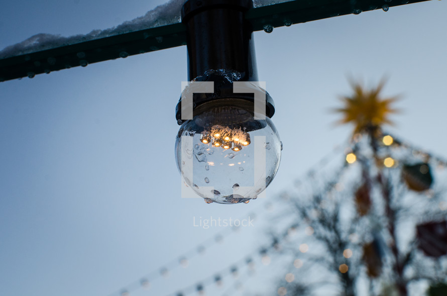 An individual light in a string of outdoor lights.